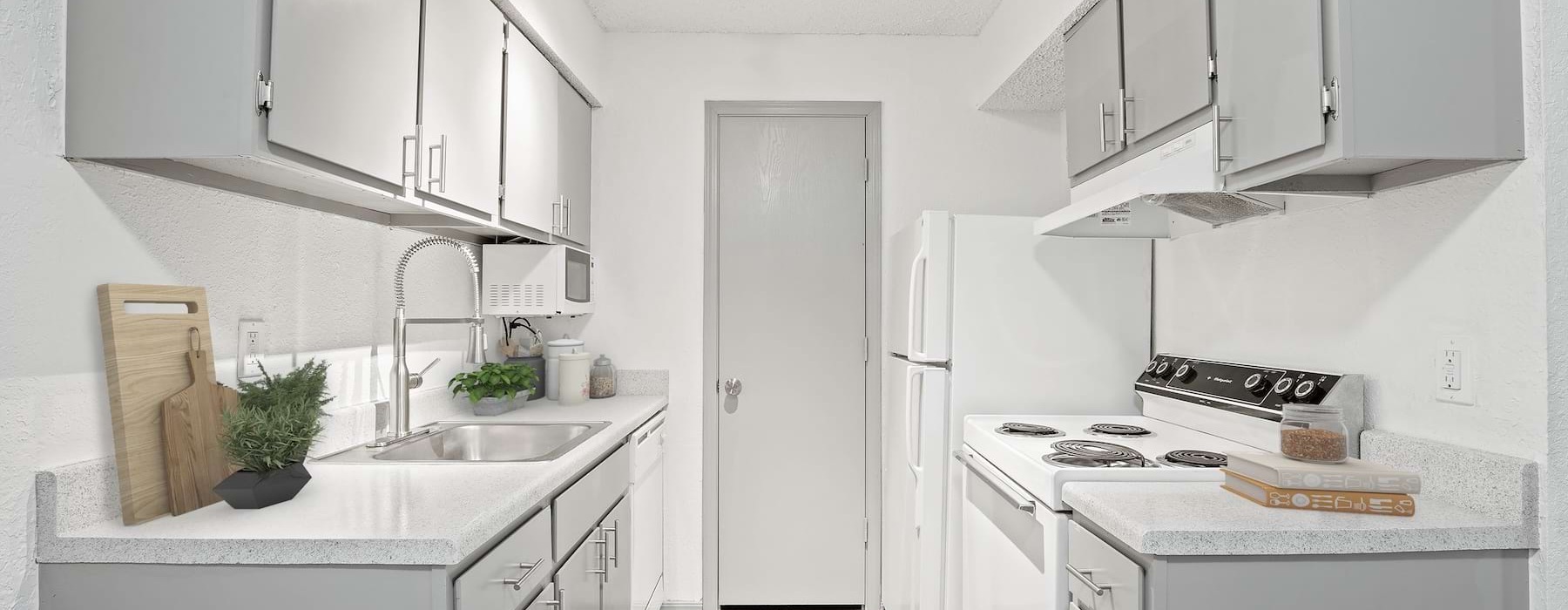 A kitchen with gray cabinets at Eagle Point 2 bedroom apartments in Tulsa, OK.